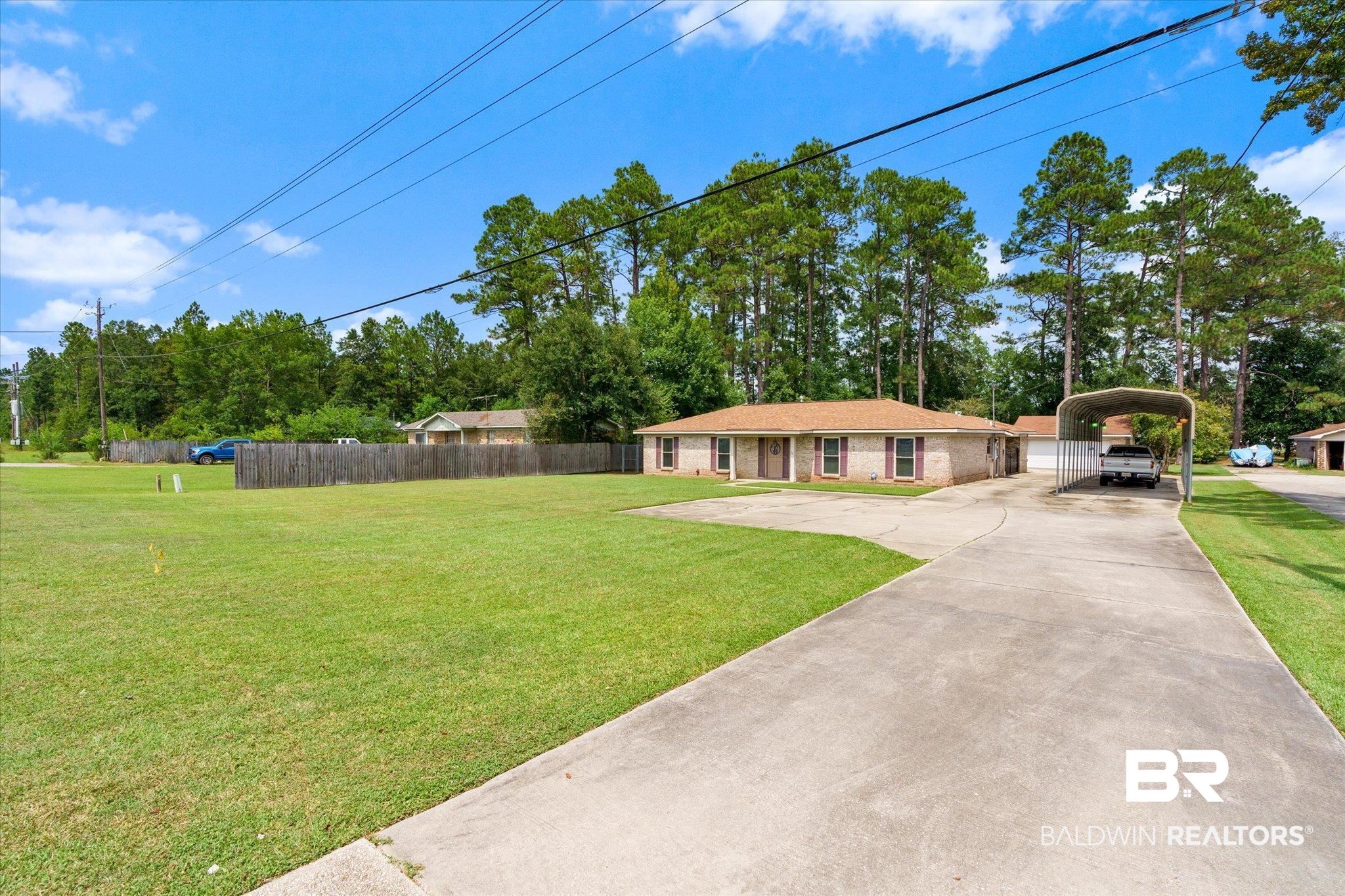 1604 Celeste Road Saraland, AL 36571 - Photo 29 of 31 View of front of house with a carport and a front yard
