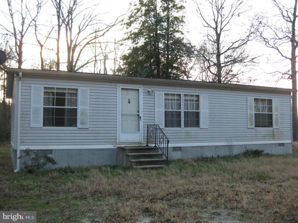 a view of house with backyard space and garden