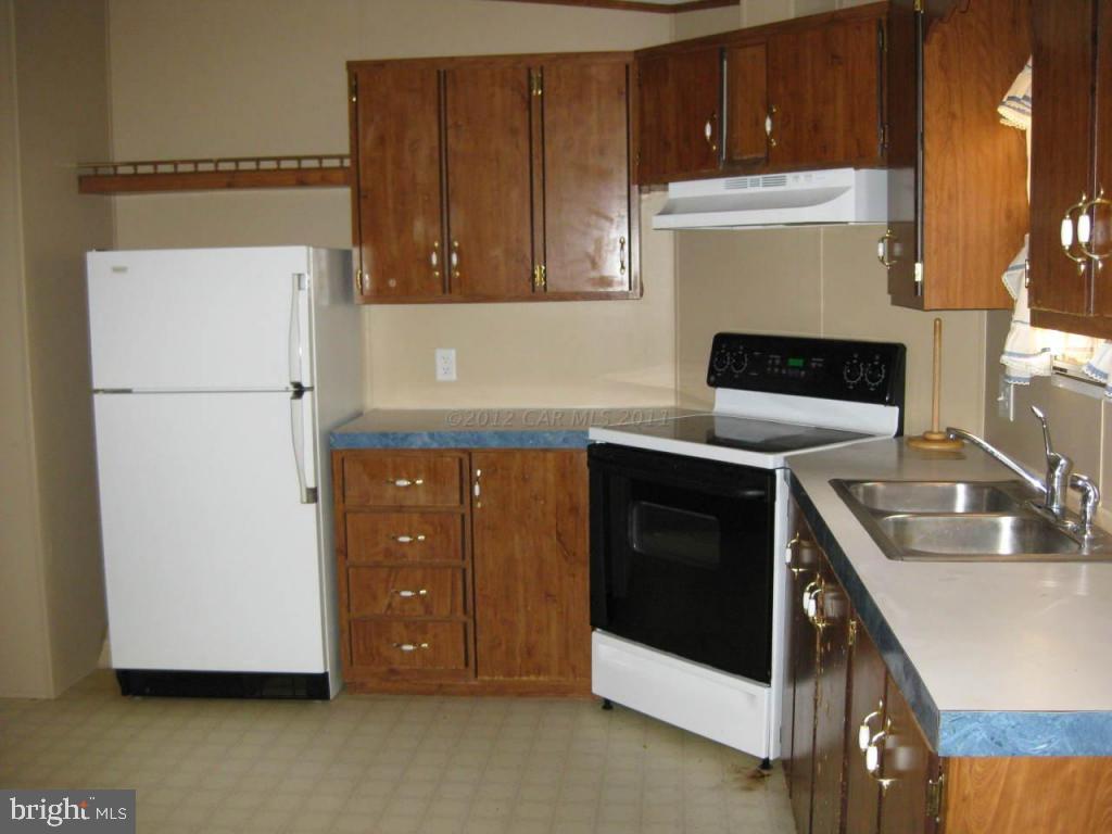 33233 Bob Smith Road Parsonsburg, MD 21849 - Photo 5 of 10 a kitchen with a refrigerator sink and cabinets