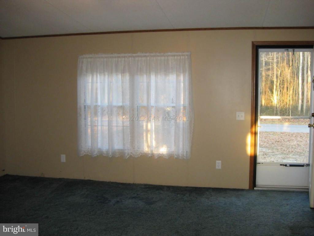 33233 Bob Smith Road Parsonsburg, MD 21849 - Photo 8 of 10 an empty room with wooden floor and windows
