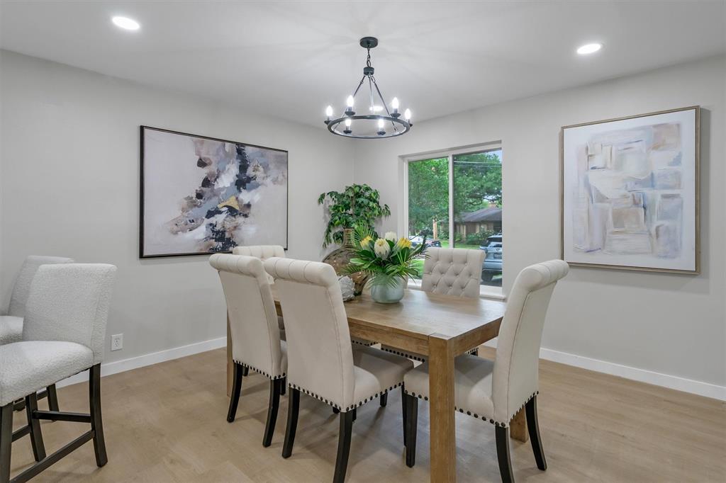 4815 Kelman Street Dallas, TX 75214 - Photo 15 of 37 Dining area featuring wood-finish flooring, recessed lighting, and a contemporary chandelier