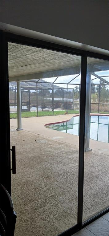 738 Flamingo Drive Apollo Beach, FL 33572 - Photo 11 of 15 a view of a room with wooden floor and a floor to ceiling window