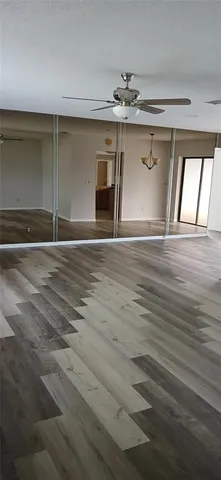 a view of a livingroom with a ceiling fan and window