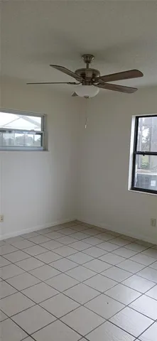a view of a room with wooden floor and a floor to ceiling window