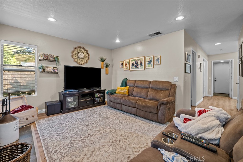 27687 Ron Ridge Drive Saugus, CA 91350 - Photo 12 of 50 a living room with furniture and a flat screen tv