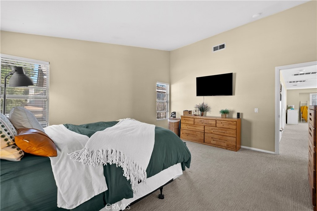 27687 Ron Ridge Drive Saugus, CA 91350 - Photo 21 of 50 a bedroom with a bed and flat screen tv