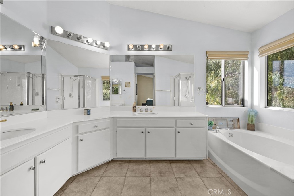 27687 Ron Ridge Drive Saugus, CA 91350 - Photo 23 of 50 a spacious bathroom with a granite countertop sink mirror and a bathtub