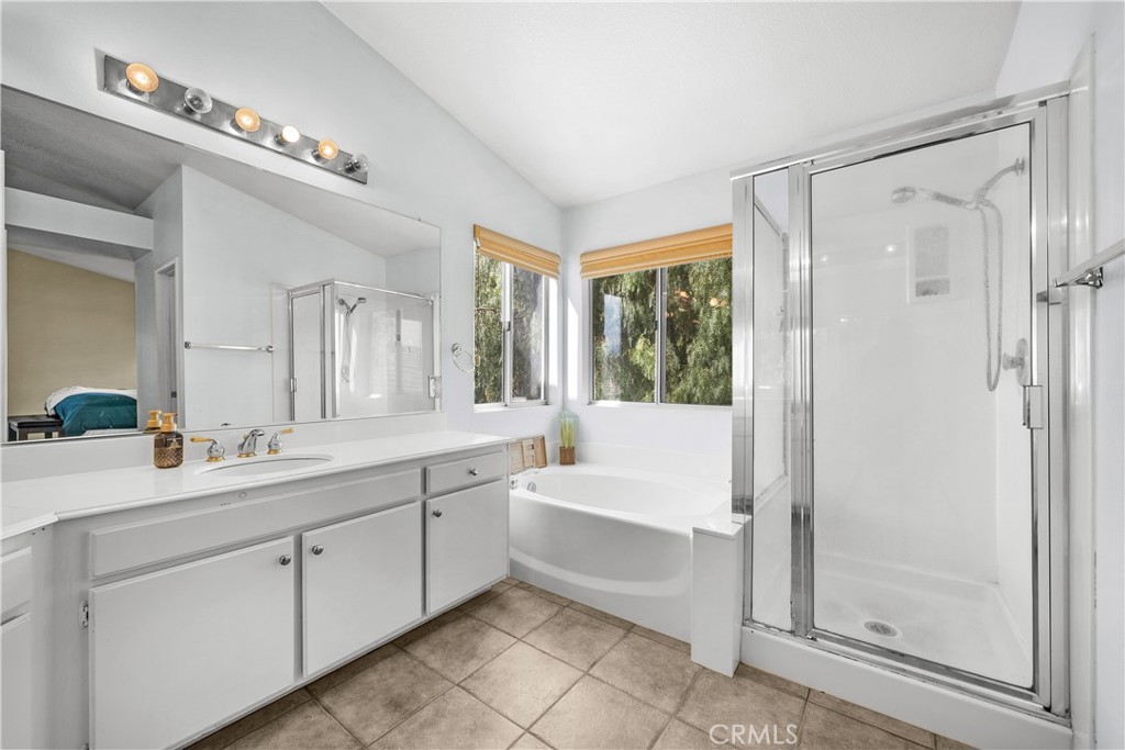 27687 Ron Ridge Drive Saugus, CA 91350 - Photo 24 of 50 a bathroom with a bathtub a double vanity sink and mirror