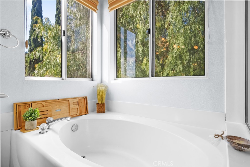 27687 Ron Ridge Drive Saugus, CA 91350 - Photo 26 of 50 a bathroom with a bathtub and window