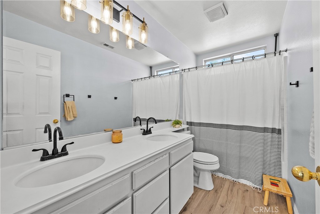 27687 Ron Ridge Drive Saugus, CA 91350 - Photo 33 of 50 a bathroom with a sink a toilet and shower