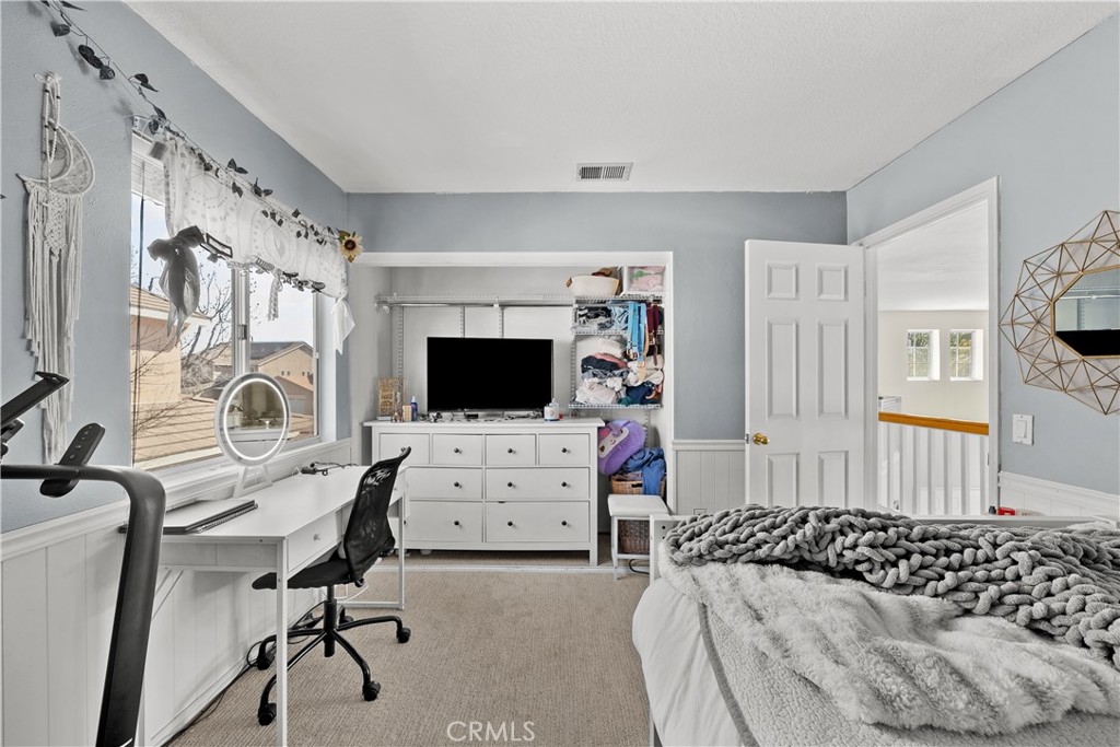 27687 Ron Ridge Drive Saugus, CA 91350 - Photo 36 of 50 a bedroom with furniture and a flat screen tv
