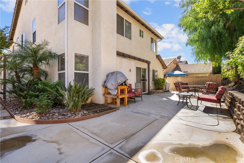 27687 Ron Ridge Drive Saugus, CA 91350 - Photo 37 of 50 a view of a patio with table and chairs and potted plants