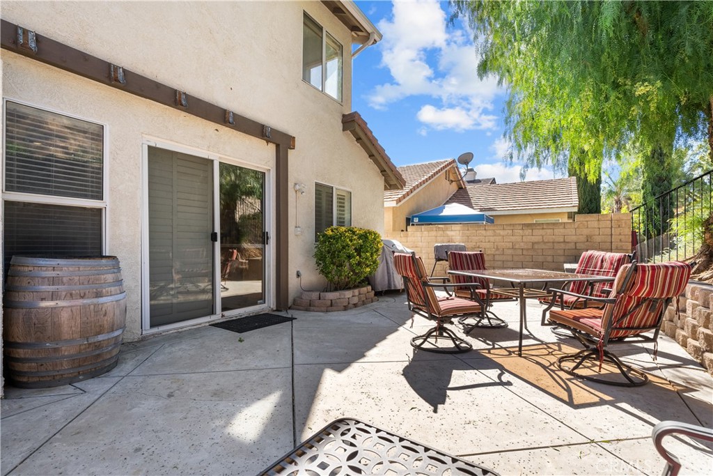 27687 Ron Ridge Drive Saugus, CA 91350 - Photo 38 of 50 a view of a patio with table and chairs and potted plants