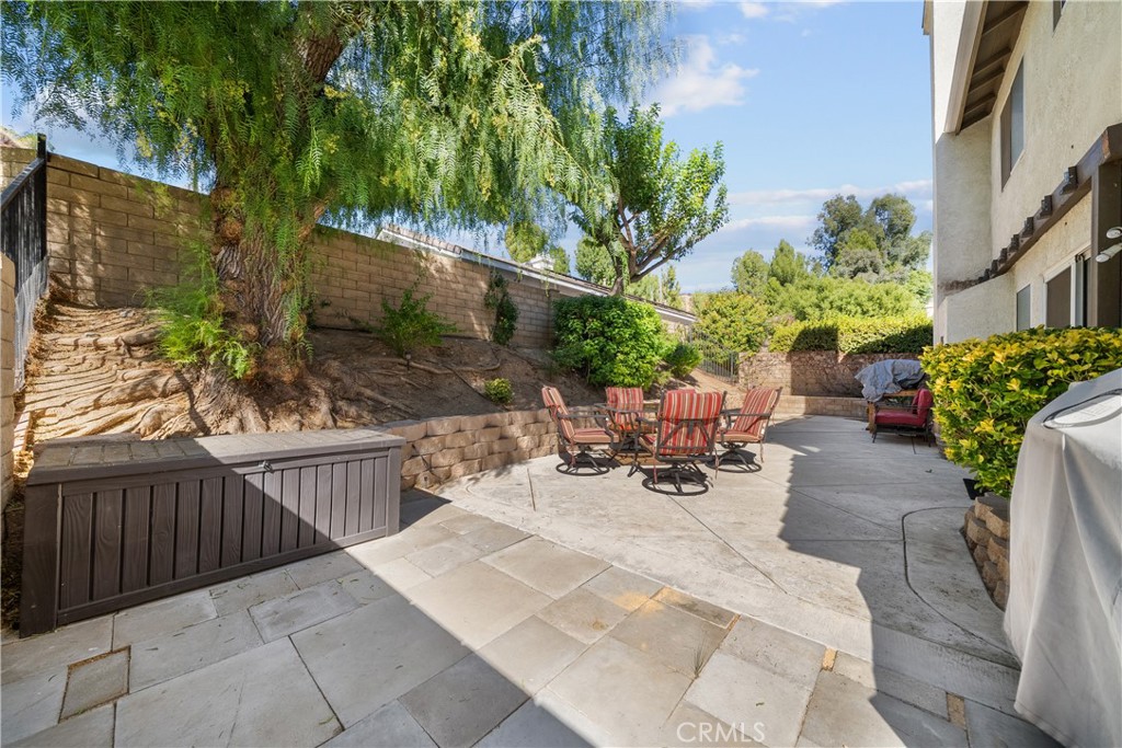 27687 Ron Ridge Drive Saugus, CA 91350 - Photo 39 of 50 a view of a patio with table and chairs and potted plants