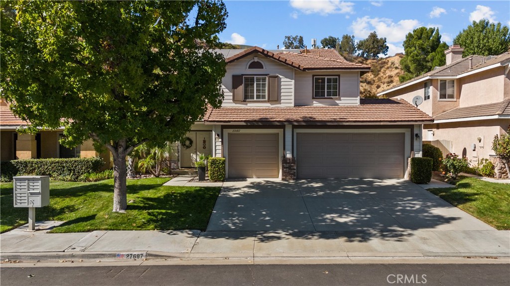27687 Ron Ridge Drive Saugus, CA 91350 - Photo 41 of 50 a front view of a house with a yard and garage
