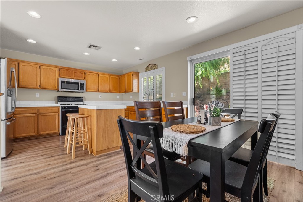 27687 Ron Ridge Drive Saugus, CA 91350 - Photo 9 of 50 a view of a dining room with furniture window and wooden floor