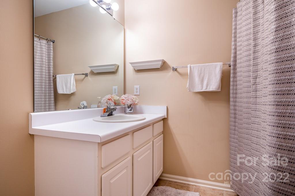 17341 Villanova Road Huntersville, NC 28078 - Photo 11 of 17 a bathroom with a sink and a mirror