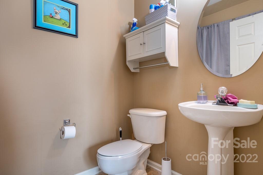 17341 Villanova Road Huntersville, NC 28078 - Photo 13 of 17 a bathroom with a toilet sink and mirror