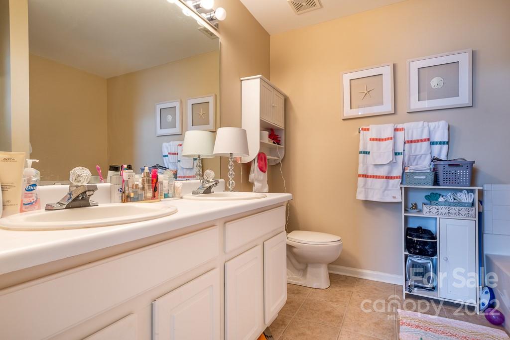 17341 Villanova Road Huntersville, NC 28078 - Photo 16 of 17 a bathroom with a sink mirror and toilet