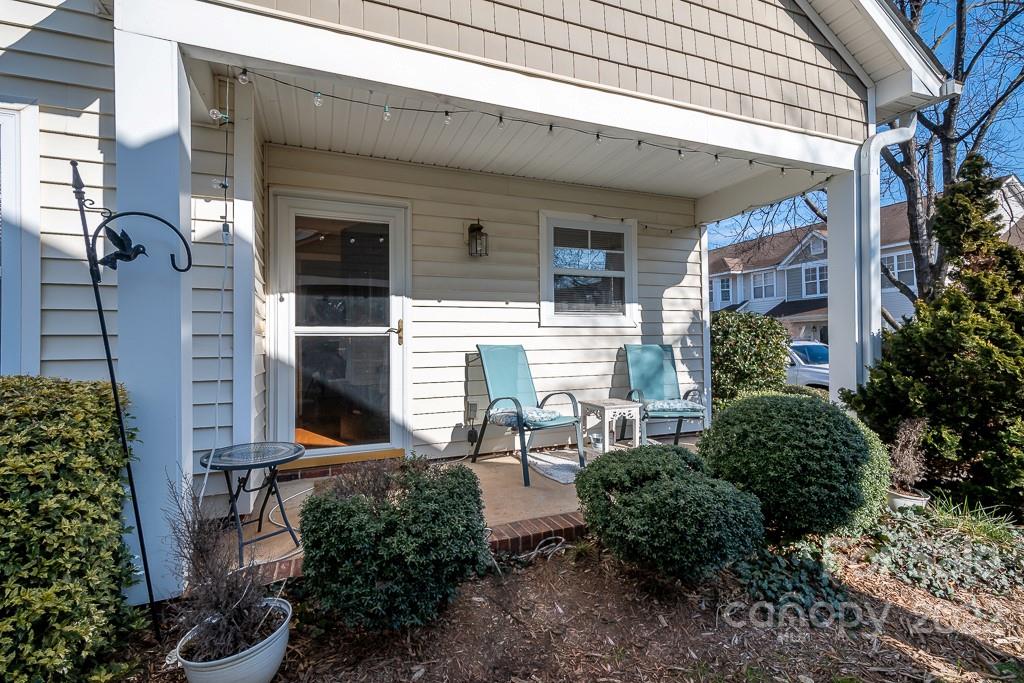 17341 Villanova Road Huntersville, NC 28078 - Photo 17 of 17 a view of a patio with table and chairs and potted plants