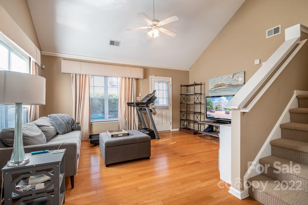 17341 Villanova Road Huntersville, NC 28078 - Photo 4 of 17 a living room with furniture floor to ceiling window and a flat screen tv