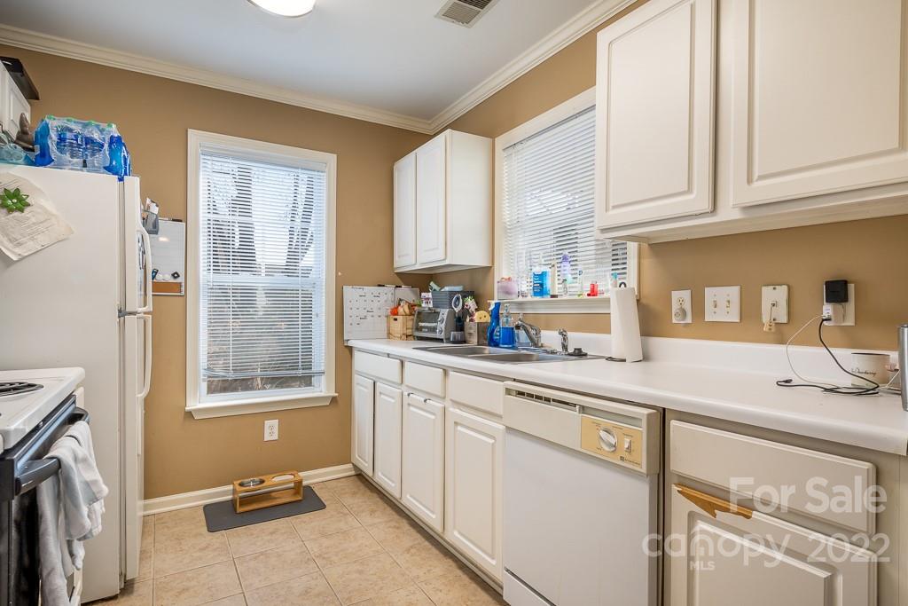 17341 Villanova Road Huntersville, NC 28078 - Photo 8 of 17 a kitchen with stainless steel appliances a sink a window and cabinets