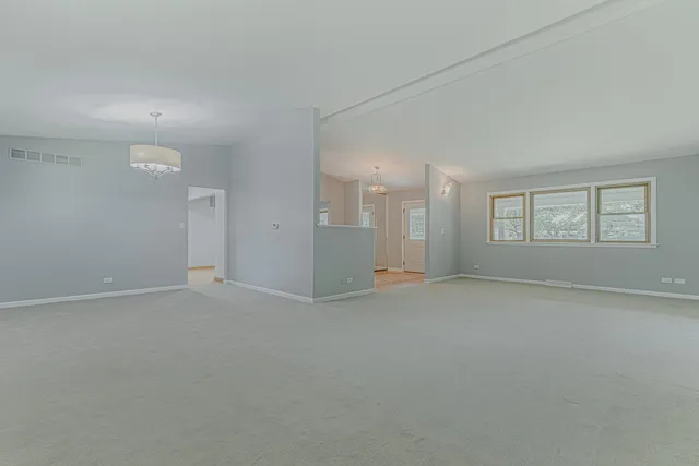 an empty room with a empty space and window