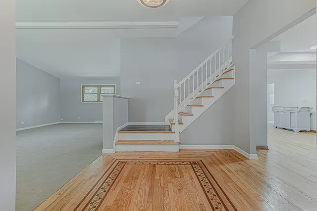 a view of entryway and hall with wooden floor