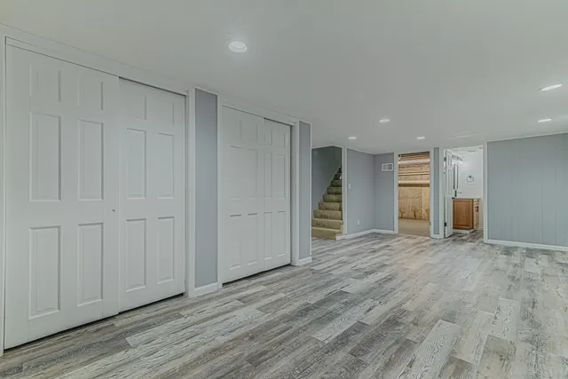 a view of empty room with wooden floor