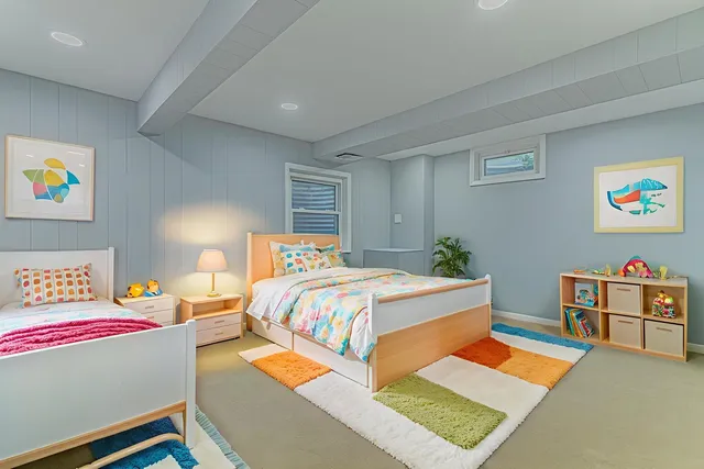 a bedroom with bed and painting on the wall