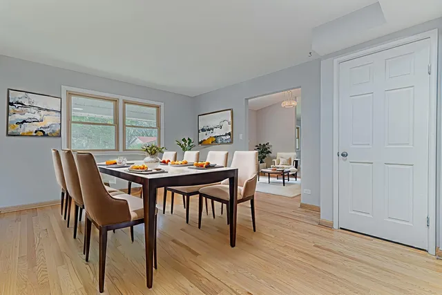 a view of a dining room with furniture window and wooden floor