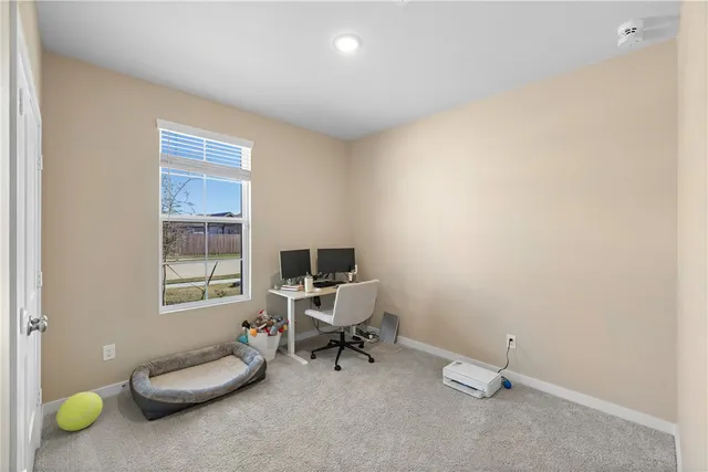 a view of a room with chairs and a window