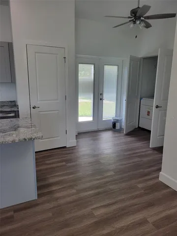 a view of a kitchen with wooden floor and a sink