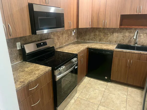 a kitchen with a stove and a microwave