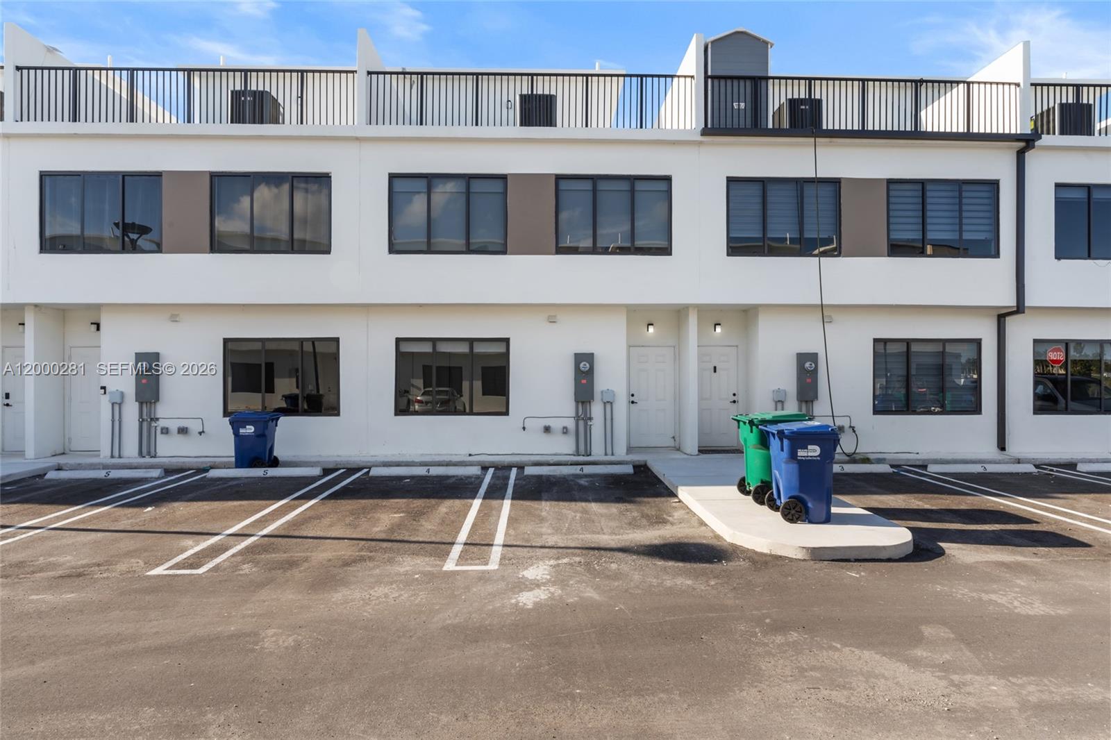 14513 Southwest 261st Street, Unit EFFICIENCY Homestead, FL 33032 - Photo 2 of 9 a front view of a building with a street view