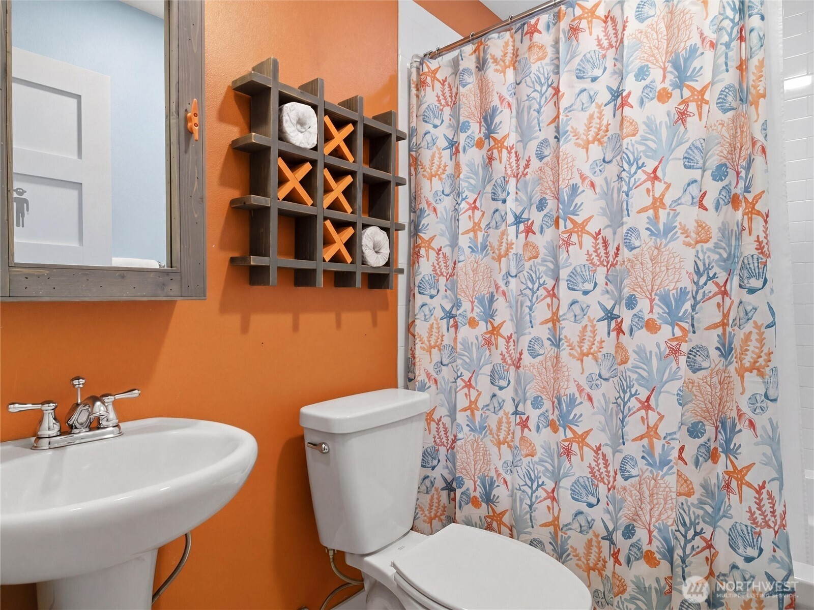 269 Compass Street Pacific Beach, WA 98571 - Photo 26 of 38 a bathroom with a sink and mirror with toilet