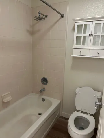 a bathroom with a sink a toilet and bathtub