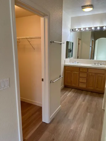 a bathroom with a double vanity sink and a mirror