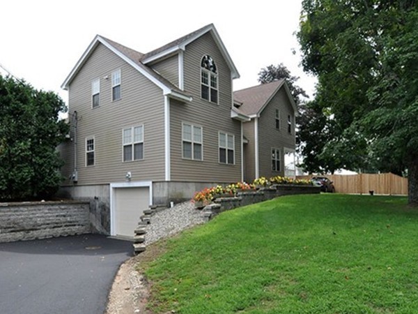 a front view of a house with a garden and yard