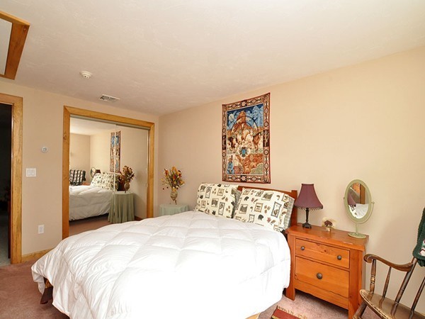 22 Hudson Road Stow, MA 01775 - Photo 22 of 28 a bedroom with a bed and wooden floor