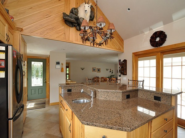 22 Hudson Road Stow, MA 01775 - Photo 4 of 28 a kitchen with stainless steel appliances granite countertop a sink and a refrigerator
