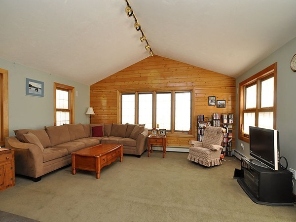 22 Hudson Road Stow, MA 01775 - Photo 8 of 28 a living room with furniture flat screen tv and a large window