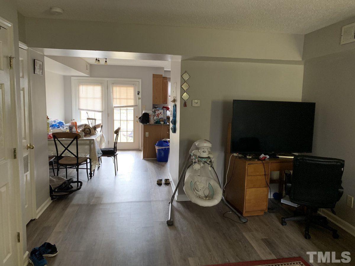 145 Jones Franklin Road, Unit D Raleigh, NC 27606 - Photo 3 of 14 a living room with furniture and a flat screen tv