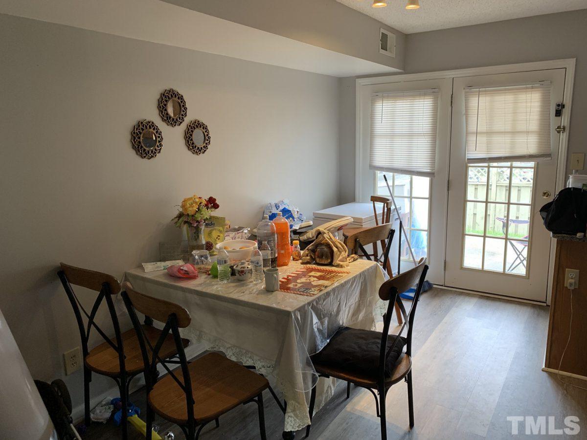 145 Jones Franklin Road, Unit D Raleigh, NC 27606 - Photo 5 of 14 a dining room with furniture and windows