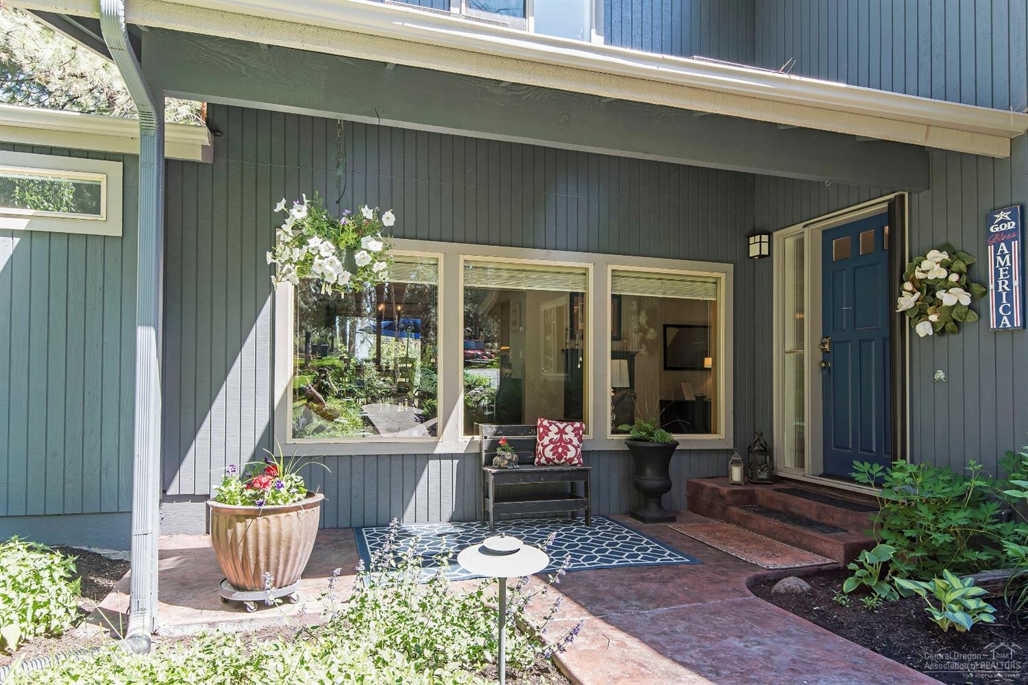 20328 Donkey Sled Road Bend, OR 97702 - Photo 2 of 25 a front view of a house with outdoor seating and plants