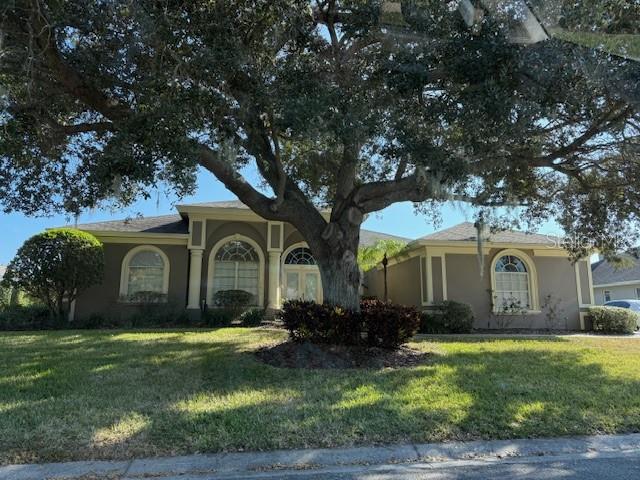 a front view of house with yard and green space