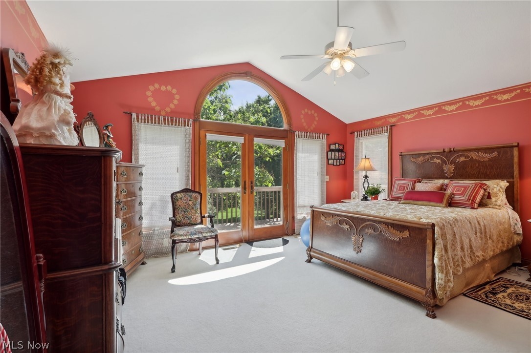 1534 West Comet Road Clinton, OH 44216 - Photo 29 of 43 Master Bedroom located just off the living room. Vaulted ceiling, plush carpet, ceiling fan, and French door with access to the wrap around deck and view of the flowering tree.