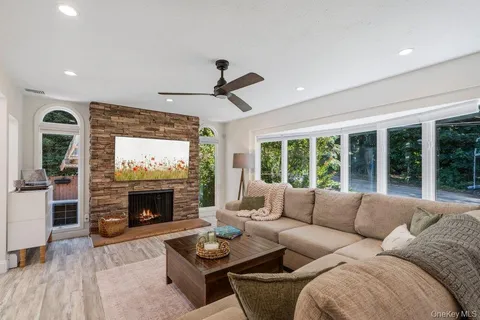 a living room with furniture and a fireplace
