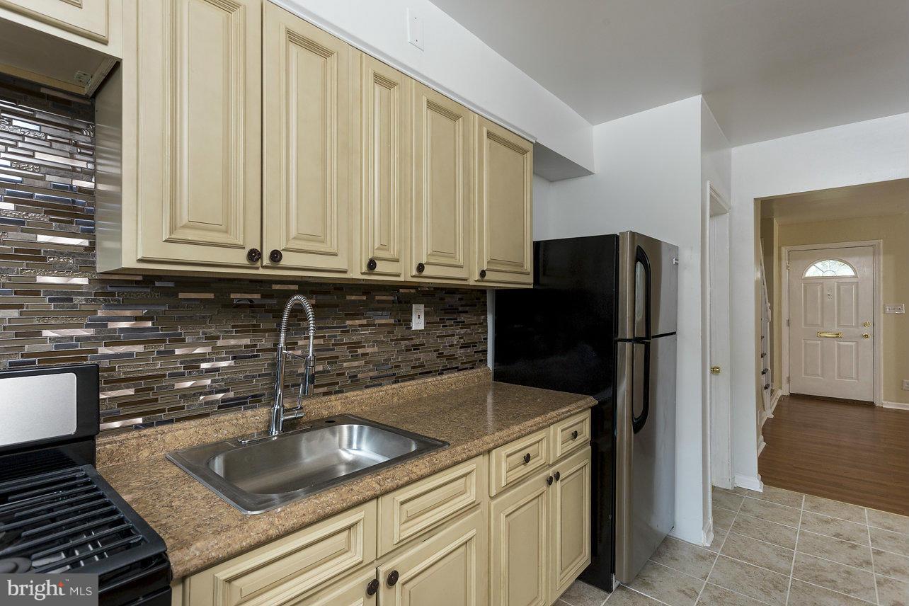 4658 Marble Hall Road Baltimore, MD 21239 - Photo 12 of 23 a kitchen with stainless steel appliances granite countertop a refrigerator and a sink