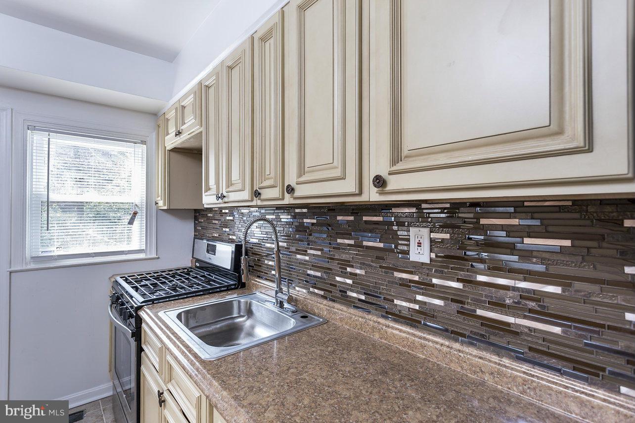 4658 Marble Hall Road Baltimore, MD 21239 - Photo 13 of 23 a kitchen with granite countertop a sink and a stove top oven